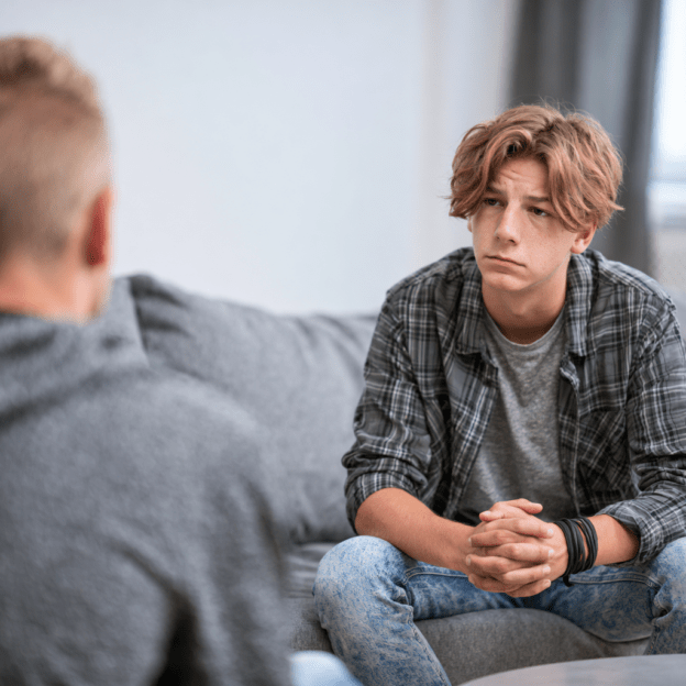 Teen speaking with a counselor during an individual therapy session at The Crossroads Program, representing how professional teen opioid rehab works through compassionate counseling, family involvement, peer support, and outpatient addiction treatment that helps teens build healthy coping skills and lasting recovery.